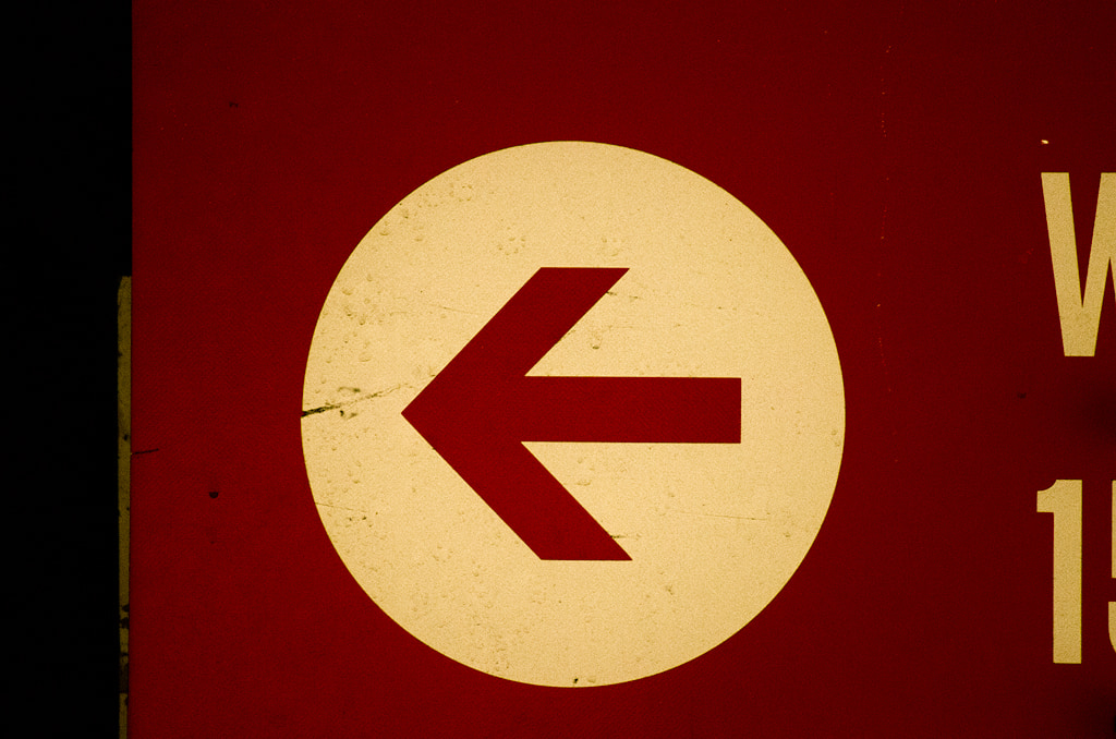Red Arrow on White Circle