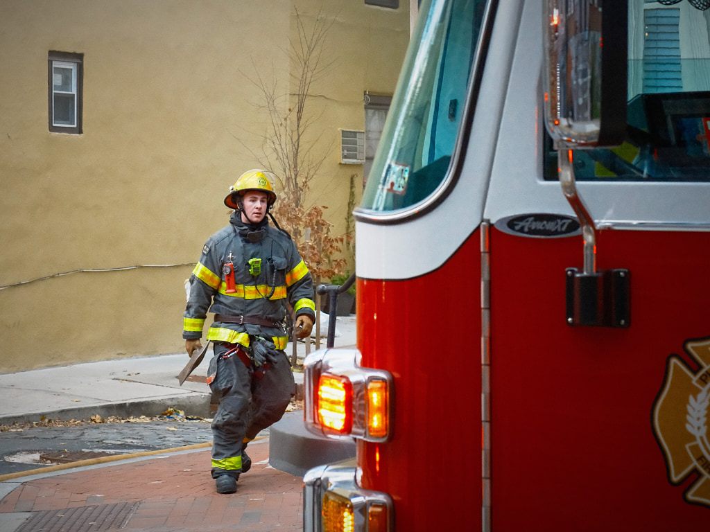 Fireman carrying an axe.