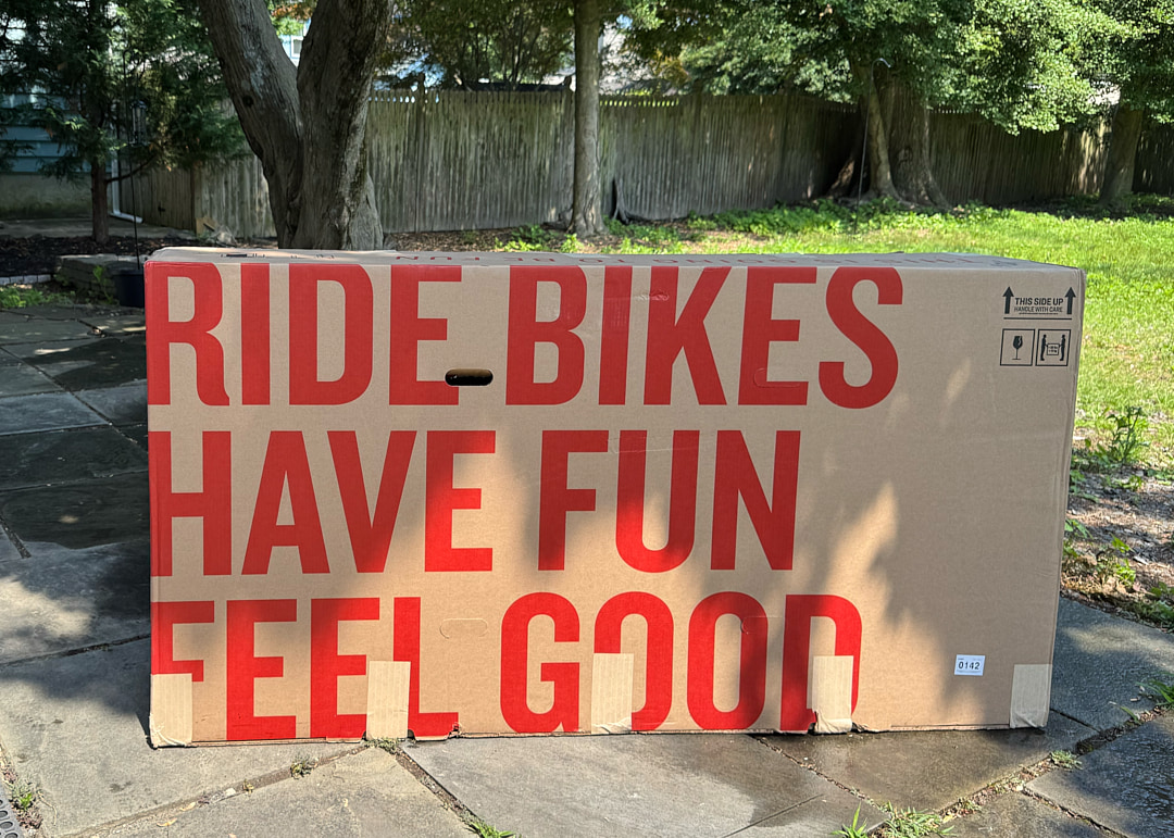 Ride Bikes Have Fun Feel Good written on a box in large red lettering.