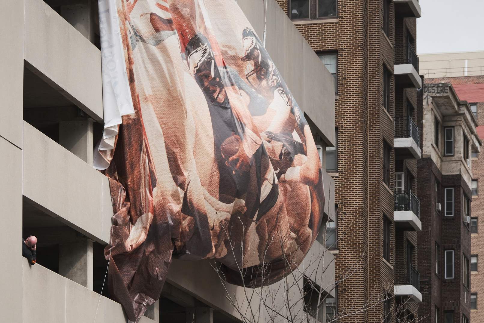 A very large Eagles banner overtaken by wind.